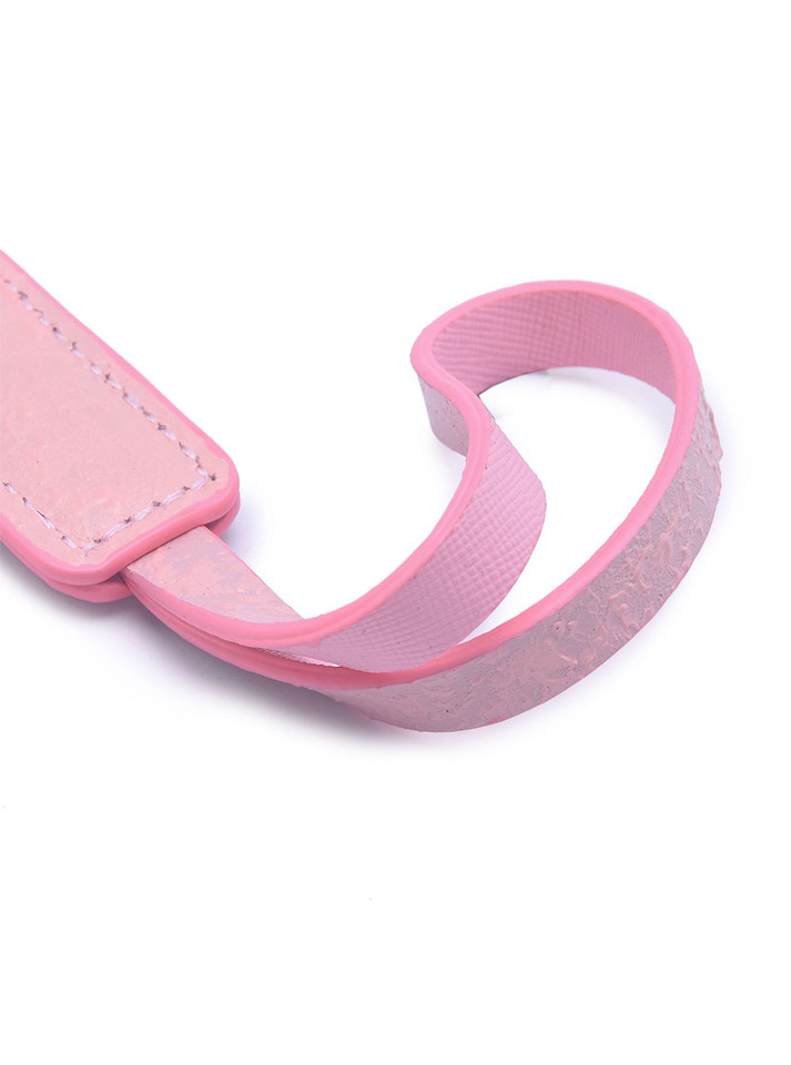 Close-up of the hand-distressed pink leather surface showing its detailed texture.