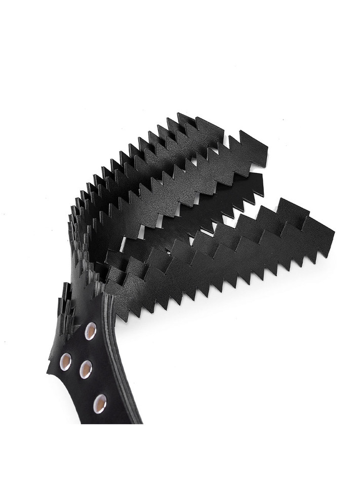 Close-up of black PU leather zigzag flogger with rivet detailing.