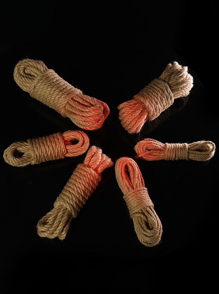 Six handmade jute ropes coiled against a dark background, showcasing their rustic texture.