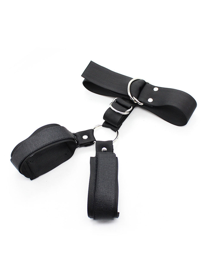 Wrist cuffs fastened tightly, showing restraint functionality
