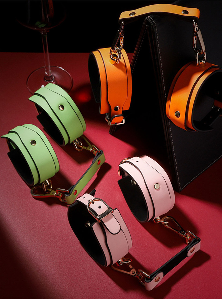 Connected wrist and ankle cuffs displayed on a red background