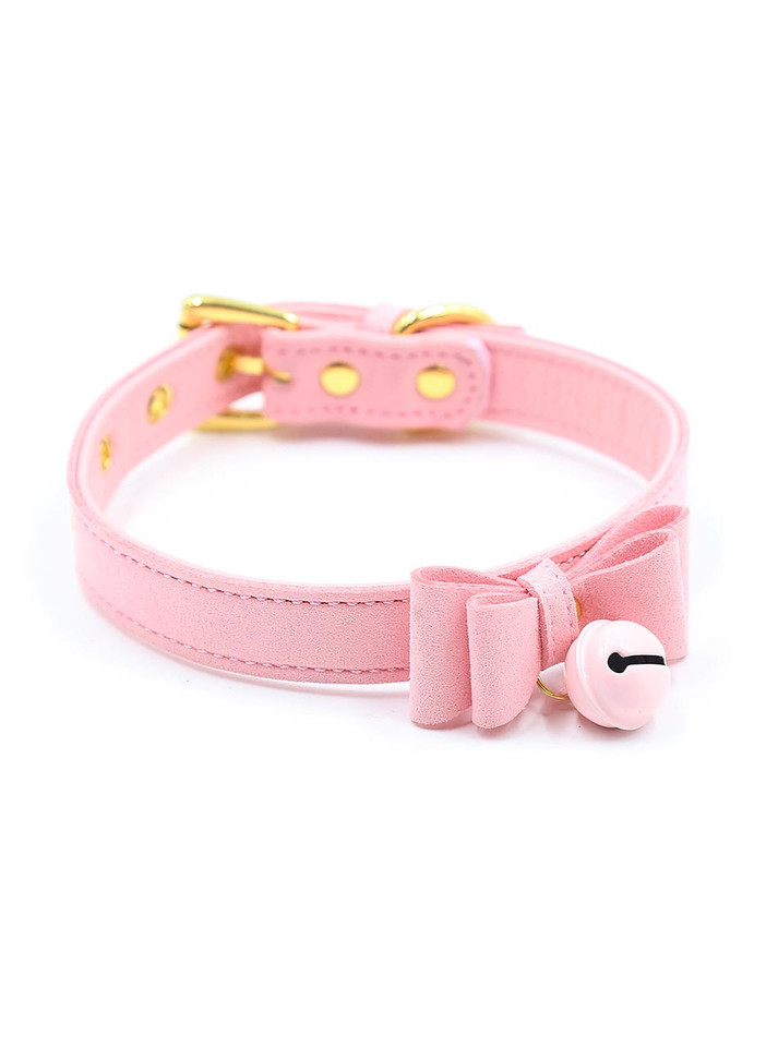 A pink faux leather choker with a bow and jingling bell.