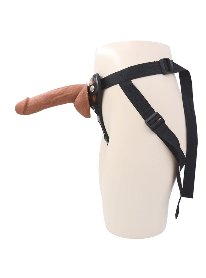 Side view of realistic veiny dildo in adjustable harness
