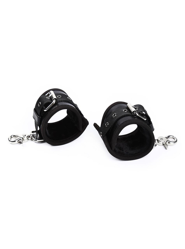 Angled view of two black leather cuffs with silver buckles and detachable clips