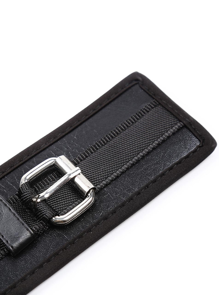Close-up of the buckle area on the leather strap with visible texture and stitching