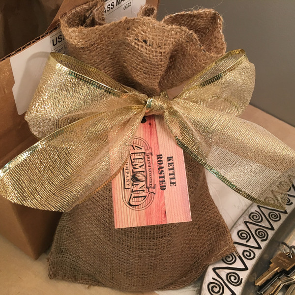 One lb. of our of our most popular flavored nuts in a real burlap bag, elegantly tied with a lace bow.  As an added touch, customize this gift with your company's logo or message. One lb. of our of our most popular flavored nuts in a real burlap bag, elegantly tied with a lace bow.  As an added touch, customize this gift with your company's logo or message.