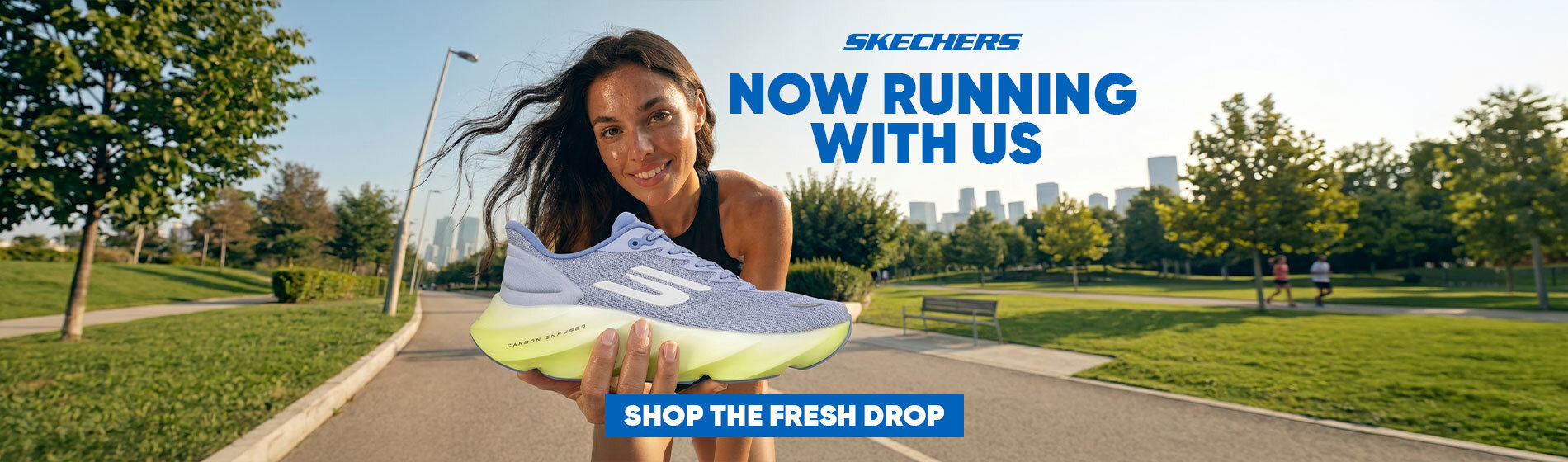 Graphic, person holding light‑purple Skechers running shoe with neon‑yellow sole toward the camera in sunny park with trees, grass, paved path and distant city skyline, text, Comfort and Style Every Step of the Way with SKECHERS - Now Part of Our Lineup, Shop New Arrivals Today!