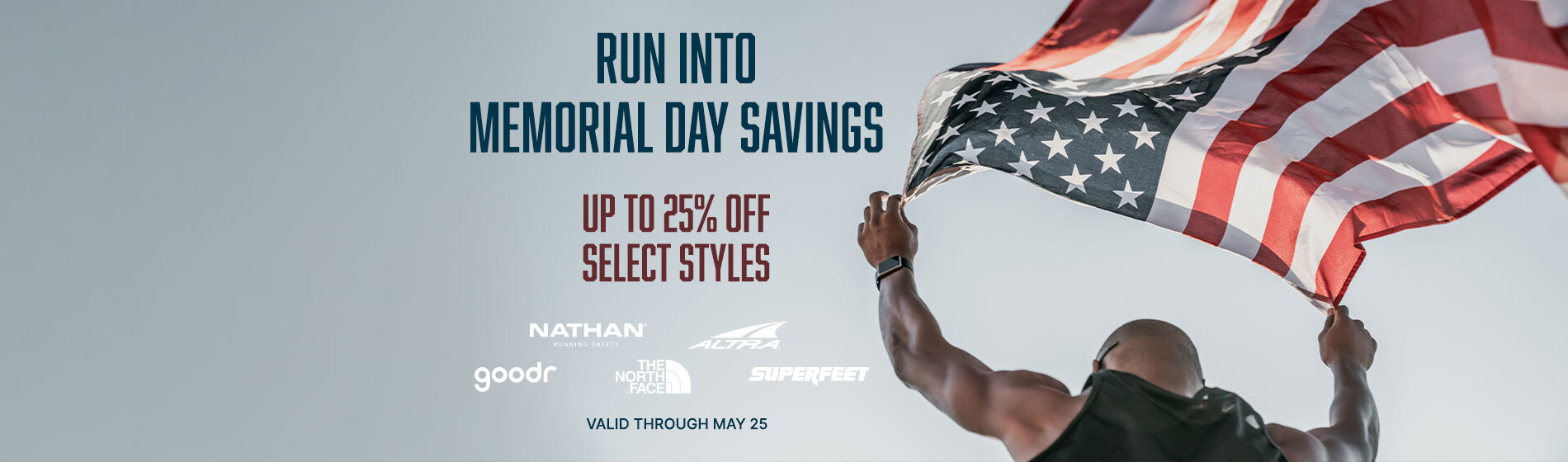 Graphic, patriotic scene with person holding American flag against open sky, text, Run Into Memorial Day Savings — Up to 25% OFF Select Styles from Nathan Sports, The North Face, Altra, Superfeet & Goodr