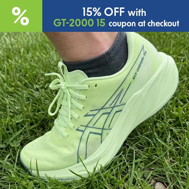 graphic, close-up of a person's foot stepping on green grass wearing a light green ASICS GT-2000 15 running shoe with dark accents, text, Meet the all-new ASICS GT-2000 15 and enjoy a launch-only 15% discount with code GT-2000-15 at checkout