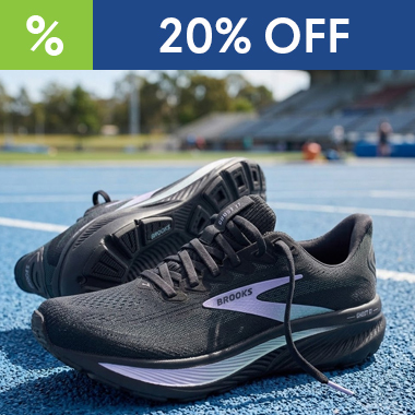 graphic, close-up of a pair of black Brooks Ghost 17 running shoes with purple accents on a blue running track, text, BROOKS Ghost 17 Running Shoes are 20% OFF  — don’t miss the price drop!