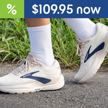 graphic, close-up of a person's legs walking on asphalt wearing white socks and off-white Brooks running shoes with a dark blue logo, text, BROOKS Ghost Max 3 Running Shoes - 31% OFF now