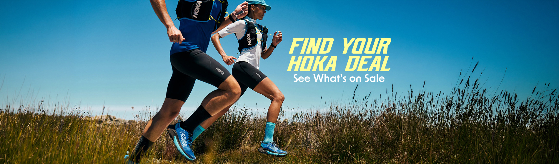 graphic, a man and a woman trail running through tall grass wearing hydration vests and bright blue HOKA shoes under a clear blue sky, text, FIND YOUR HOKA DEAL: See What's on Sale