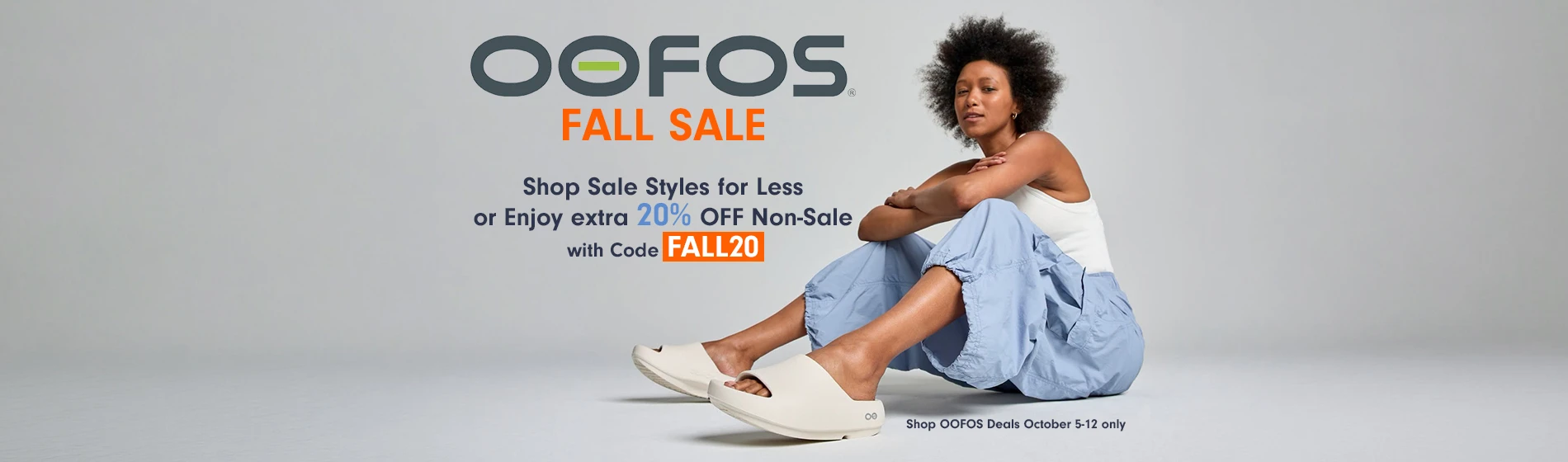graphic, a woman sitting on a light grey floor wearing a white tank top, loose light blue pants, and cream-colored OOFOS slide sandals, text, OOFOS Fall Sale: Save up to 20% on Sale Styles - or Enjoy extra 20% OFF Non-Sale with Code FALL20. Shop OOFOS Deals October 5-12 only!