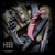 Halfbreed Blades Close Quarters fixed karambit and red true-weight steel trainer displayed on camouflage Kevlar gear