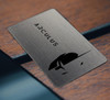 An image of a silver Arculus card laying on a wooden table