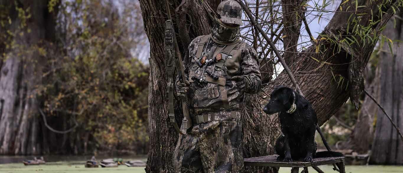 man hunting with dog