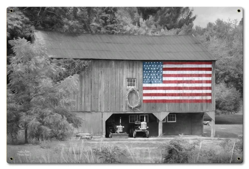 Barn Flag metal sign 24 x 16 inches showing a weathered wooden country barn in black and white with a colorful American flag on the side and farm equipment beneath