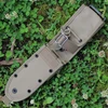 The ESEE-5/6 MOLLE Back (ESEE-52-MB-K) in khaki nylon, shown with its adjustable handle retention strap, pommel flap, built-in belt loops, and MOLLE straps, designed to mount to ESEE-5 and ESEE-6 hard sheaths.