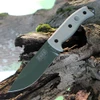 The ESEE-5 (ESEE-5P-OD-E) shown with its 5.25-inch 1095 saber ground drop point blade in an OD Green finish, sharpened glass breaker pommel, fire-making bow drill divot, tan Micarta handle scales, and its black Kydex belt sheath.