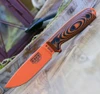 The ESEE-4 3D Handle (ESEE-4POR-006) shown with its 4.50-inch 1095 drop point blade in an Orange finish and tall flat grind, 3D orange and black G-10 handle scales, and its injection-molded black polymer sheath.