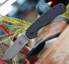The ESEE Avispa (BRK1303) shown with its 3.50-inch SK-5 drop point blade in a stonewash finish and flat grind, modeled after the Laser Strike fixed blade, textured black polymer handle scale with stainless steel frame lock, and pocket clip for tip-up or tip-down carry.