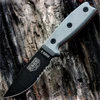 The ESEE-3 Fixed Blade (ESEE-3SM-MB-CO) shown with its 3.88-inch 1095 carbon steel drop point blade in a black finish with partial serration and flat grind, gray Micarta handle scales with a modified pommel, and its injection-molded Coyote Brown sheath with MOLLE back attachment.