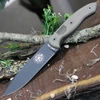 The ESEE-CM6 (ESEE-CM-6-TG) shown with its 5.88-inch 1095 clip point blade in a Tactical Gray finish and flat grind with a sharpened swedge, full-sized tan Micarta handle scales, and its black Kydex sheath with multiple carry options.