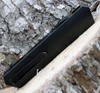 Boker Plus Kwaiken OTF Black 06EX551 close-up of the CNC-milled black aluminum handle texture and hardware.
