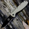The ESEE Zancudo (BRKR1DTB) shown with its 2.94-inch AUS-8 drop point blade in a black finish and flat grind, Desert Tan polymer handle with steel frame lock, and reversible pocket clip for tip-up or tip-down carry.