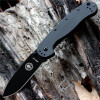 The ESEE Avispa (BRK1301B) shown with its 3.50-inch AUS-8 drop point blade in a black finish and flat grind, black polymer handle with steel frame lock, and pocket clip for tip-up or tip-down carry.