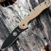 The ESEE Avispa (BRK1301CBB) shown with its 3.50-inch AUS-8 drop point blade in a black finish and flat grind, Coyote Brown polymer handle with steel frame lock, and pocket clip for tip-up or tip-down carry.