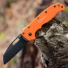 The Demko AD20.5 Shark Lock open, showing its 3.25-inch black-finished, flat-ground AUS-10A Shark Foot blade with a straight plain edge, orange textured Grivory scales over steel liners, the spine-mounted Shark-Lock fin, a thumb stud and thumb hole, and a tip-up pocket clip.