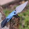 Kansept Fenrir Folding Knife (K1034A8) 3.48" Damascus Drop Point Plain Blade, Blackwashed Titanium Handle with Blue Timascus Inlay