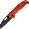 The Demko AD20.5 Shark Lock open, showing its 3.25-inch black-finished D2 Wharncliffe blade with a straight plain edge, orange textured Grivory scales over steel liners, the spine-mounted Shark-Lock fin, a thumb stud and thumb hole, and a tip-up pocket clip.