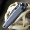 Close-up of the dark gray anodized aluminum handle on the Kershaw 7551 highlighting the titanium pivot trim ring.