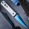 Pro-Tech Godfather BSA26.Godfather.2 shown deployed against a dark background, angled to display the full length of the knife. The sapphire blue PVD blade and satin silver aluminum handle are both clearly visible, with the stiletto profile of the Godfather frame shown in full.