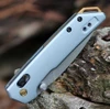 Close-up of the ice blue anodized aluminum handle on the Kershaw 2051 highlighting the gold PVD pivot accents.