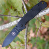 The ESEE Zancudo (BRKR2CF-B) shown with its 2.94-inch D2 drop point blade in a black finish and flat grind, black carbon fiber and G-10 handle with steel frame lock, and reversible pocket clip for tip-up or tip-down carry.