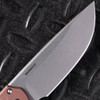 Pro-Tech Mordax BSA26.Mordax.1 shown open against a dark diamond plate background, angled to emphasize the stonewash CPM MagnaCut drop point blade. The blade's stonewash finish and flat grind are visible along the full length, with the brown aluminum handle and white pearl button visible at the base of the blade.