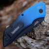 Close-up of the black and blue anodized aluminum handle and the low-profile push-button firing mechanism.e