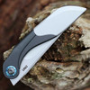 CRKT Fial 5670 profile view showing 3.63 inch Sandvik 12C27 blade with integrated bottle opener and stainless steel handle with deployed corkscrew.