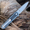 CRKT Pup 7070 profile view showing 2.09 inch AUS-10 bead blasted spear point blade and blue/black GRN handle.