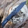 Close-up of the black-oxide finish on the D2 reverse tanto blade highlighting the reinforced tip.