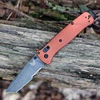 The Benchmade Bailout (537SBK-07) shown with its 3.38-inch CPM MagnaCut tanto blade in a DLC Battlewash finish with part serration, Burnt Copper anodized aluminum handle scales with a diamond-textured grip, and its tip-up reversible pocket clip. The AXIS Lock bar is visible along the spine of this ultralight tactical EDC folder.