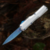 Kershaw Livewire Cryo 9000RAWBLU OTF automatic knife open showing the 3.3-inch blue MagnaCut blade and raw aluminum handle.
