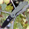 The ESEE Avispa (BRK1302ODB) shown with its 3.50-inch D2 drop point blade in a black finish and flat grind, OD Green polymer handle with steel frame lock, and pocket clip for tip-up or tip-down carry.