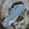 Chris Reeve Small Sebenza 31 Tanto close-up of blue thumb lug and sandblasted titanium handle.