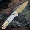 Close-up gold reverse tanto edge and flat grind on Kershaw Bel Air Pope White