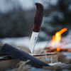 Helle Allmenn fixed blade knife with red and black dyed curly birch handle upright view