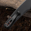 Pro-Tech Malibu BSA26.Malibu.1 shown in the closed position on a dark wood background. The black aluminum handle, copper rose PVD hardware, and pocket clip are visible, with the copper rose PVD-coated reverse tanto blade tip visible at the closed end of the frame.